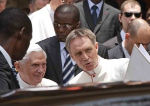 Archbishop Georg Gänswein, new Prefect of the Papal Household. Below, Gänswein with Benedict XVI during Pope’s visit to Cameroon and Angola on March 17-23, 2009 (Galazka photo).