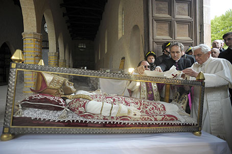 Pope Benedict XVI places a white stole on the remains of 13th-century Pope St. Celestine V during his visit to the earthquake-damaged Basilica of Santa Maria di Collemaggio in L’Aquila, Italy, April 28, 2009 (CNS photo)