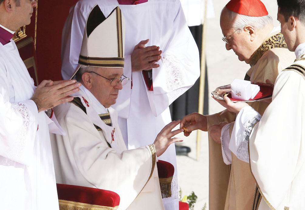 Pope Francis receives his ring from Cardinal Angelo Sodano, dean of the College of Cardinals. (CNS photo)