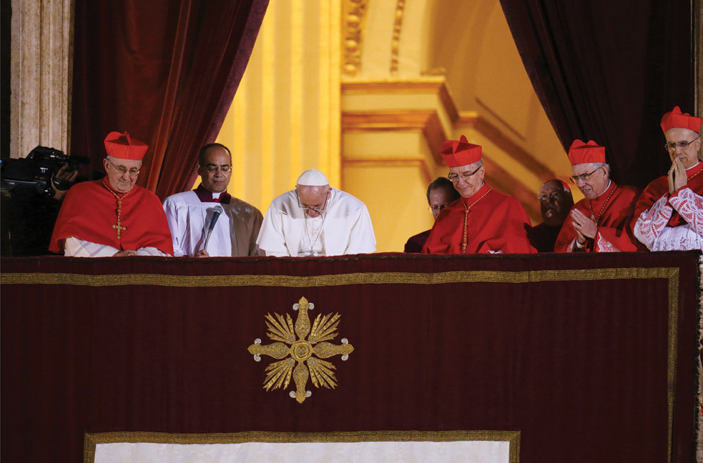 Pope Francis leads a prayer as he appears for the first time on the central balcony of  St. Peter's Basilica at the Vatican March 13. In the left corner, Cardinal Agostino Vallini, Vicar of Rome; to the right of Pope Francis, Brazilian Cardinal Claudio Hummes, Italian Cardinal Giovanni Battista Re, and Cardinal Tarcisio Bertone (Galazka photo).