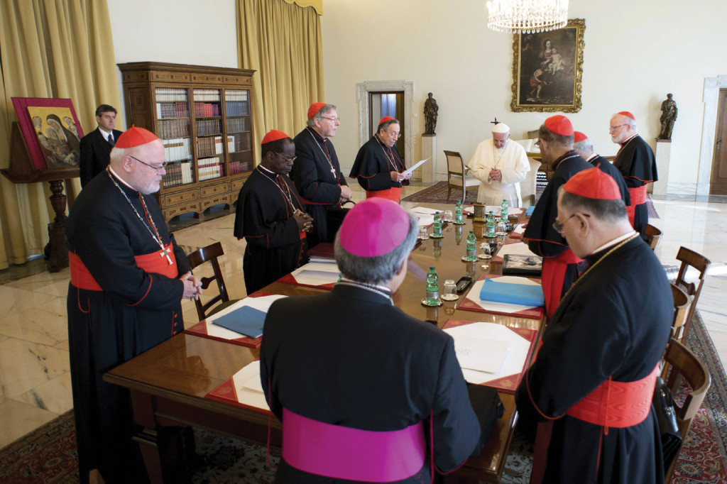 Pope Francis prays during a meeting with cardinals at the Vatican. 
