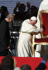 Pope Francis kneels as the crowd prays over him by singing and speaking in tongues during an encounter with more than 50,000 Catholic charismatics at the Olympic Stadium in Rome June 1.