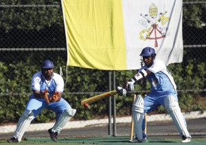 A player from a team of priests and seminarians returns a ball during a cricket training session at the Maria Mater Ecclesiae Catholic College in Rome. 