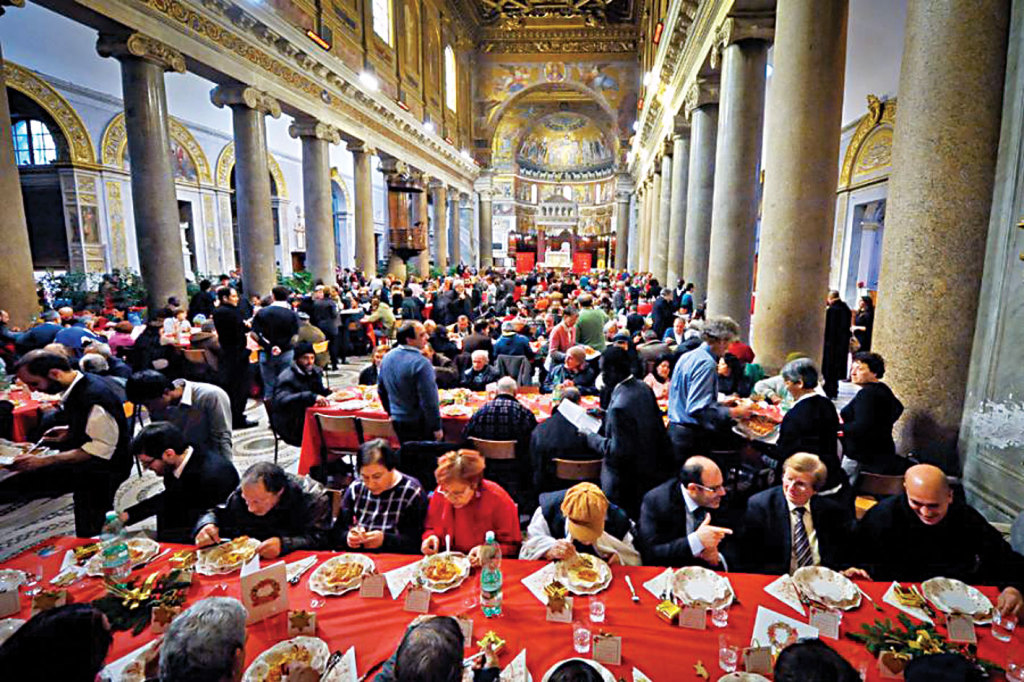 The traditional Christmas meal in the Basilica of Santa Maria in Trastevere offered to Rome’s poor by the Sant’Egidio Community .