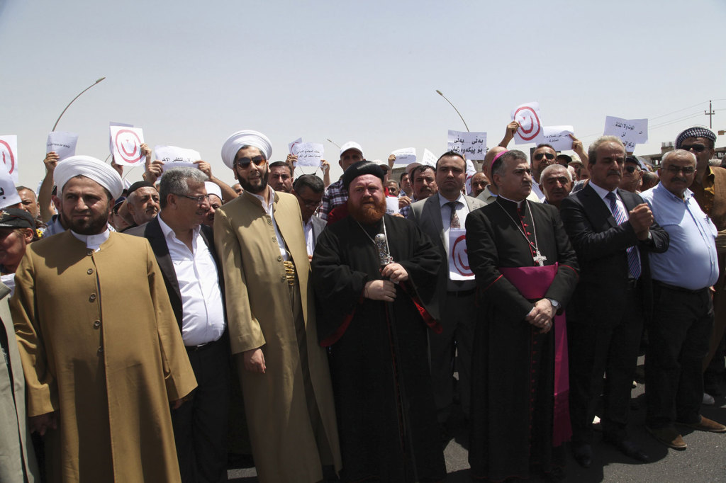 Demonstrators from various religions gather during a July 24 protest in Irbil, Iraq, against militants of the Islamic State.