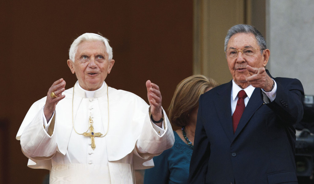 Pope Benedict XVI and Cuba’s President Raul Castro gesture to the media as they appear for a photo opportunity outside the Palace of the Revolution in Havana March 27, 2012, just one year before his resignation (CNS photo/Paul Haring).