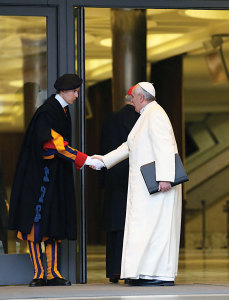 Pope Francis greets a Swiss Guard as he arrives for the works of the Consistory on February 13, 2015.