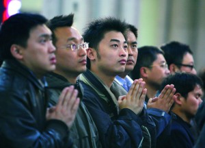Those preparing to become Catholics are recognized by the congregation during a Sunday Mass at St. Ignatius Cathedral in Shanghai, China, in March. Amid chronic tensions between the Vatican and China, there were new signs of hope this year for Catholic believers in the country, especially for those who have been loyal to the Vatican. (CNS photo/Nancy Wiechec) (Dec. 10, 2007) See YEAREND-CHINA Dec. 10, 2007.