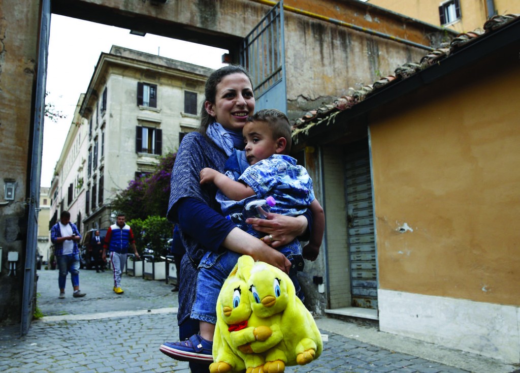 Syrian refugees Nour and her son Riad, 2, who flew to Rome with her husband, Hasan, on Pope Francis' flight from the Greek island of Lesbos, are pictured in Rome April 18. The pope brought 12 Syrian refugees back with him from a refugee camp in Lesbos. (CNS photo/Paul Haring) See SYRIAN-REFUGEES-ROME April 18, 2016.