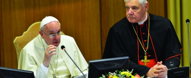 Pope Francis seated next to Cardinal Gerhard Muller