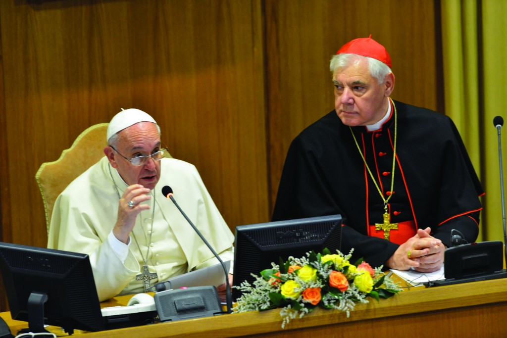 Pope Francis, seated next to Cardinal Gerhard Muller, prefect of the Vatican Congregation for the Doctrine of the Faith, discusses preservation of the family in Synod Hall at the Vatican Nov. 17 during the opening of a three-day interreligious conference on traditional marriage. (CNS photo/Chris Warde-Jones, courtesy Humanum.it) See POPE-MARRIAGE Nov. 17, 2014.