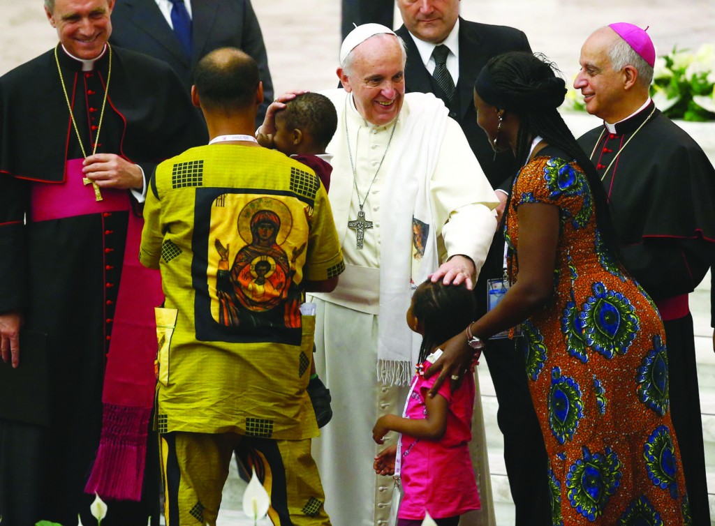 Pope Francis blesses a family Sept. 19 during a special audience with participants at a meeting for the new evangelization in Paul VI hall at the Vatican. (CNS photo/Tony Gentile, Reuters) See POPE-EVANGELIZATION Sept. 19, 2014.