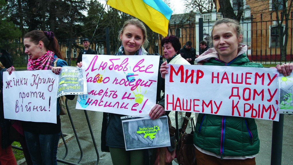 Ukrainian women hold peace placards near a military base in Ukraine's Crimea region in this March 4, 2014, file photo. (CNS photo/Artur Shvarts, EPA) See POPE-UKRAINIAN-BISHOPS March 7, 2016.