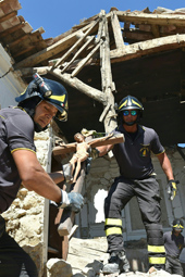 Firefighters recover a crucifix from a damaged church in the village of Rio, some 10 kms from the central Italian village of Amatrice, on August 28, 2016, four days after a 6.2-magnitude earthquake struck the region, killing nearly 300 people. Shoddy, price-cutting renovations, in breach of local building regulations, could be partly to blame for the high death toll from this week's devastating earthquake in central Italy, according to a prosecutor investigating the disaster. As questions mount over the deaths of nearly 300 people, prosecutor Giuseppe Saieva indicated that property owners who commissioned suspected sub-standard work could be held responsible for contributing to the quake's deadly impact. / AFP / ALBERTO PIZZOLI