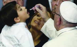 Pope Francis gives a vaccine to Rodrigo Lopez Miranda, 5, held by Mexico's first lady Angelica Rivera during a visit to the Federico Gomez Children's Hospital of Mexico in Mexico City Feb. 14. (CNS photo/Paul Haring) See POPE-MEXICO-HOSPITAL Feb. 14, 2016.
